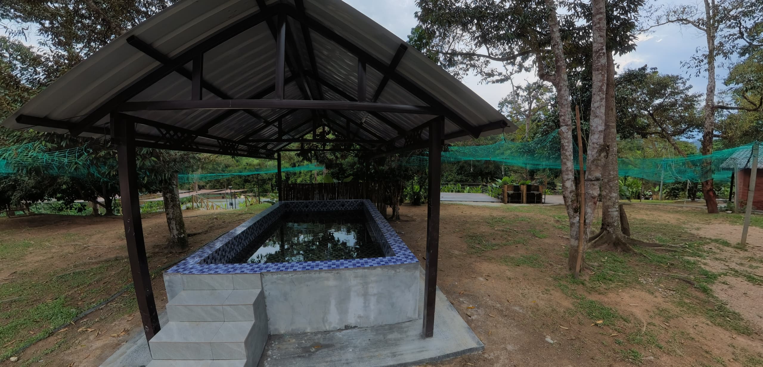 Covered mini pool with blue mosaic tiles