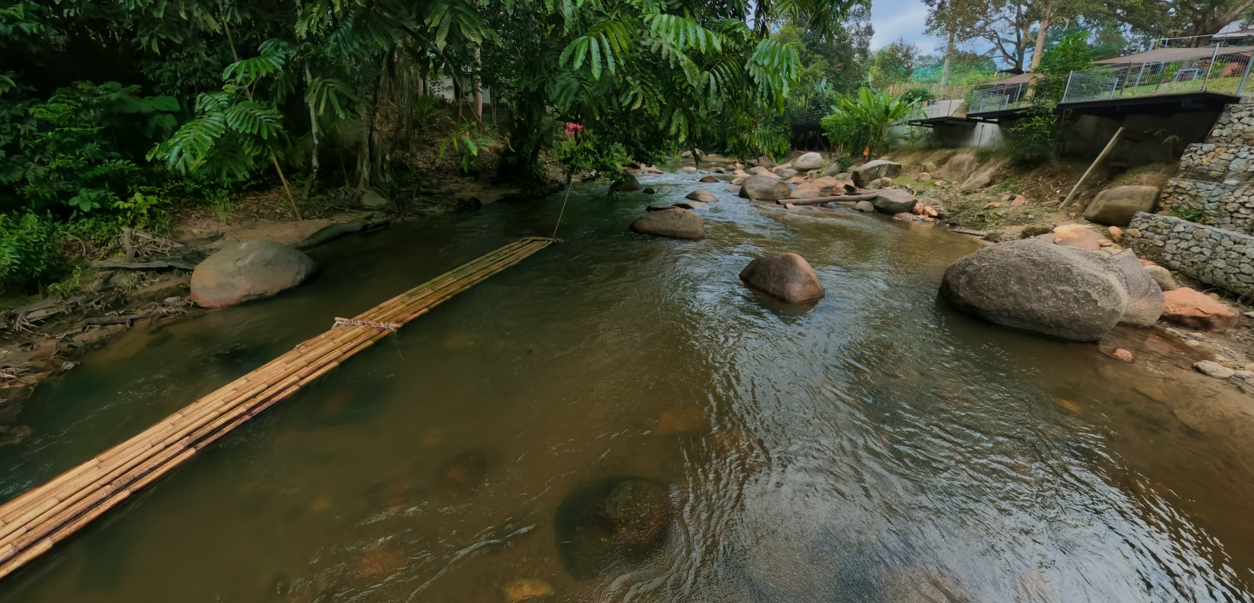 Bamboo raft on the river with boulders