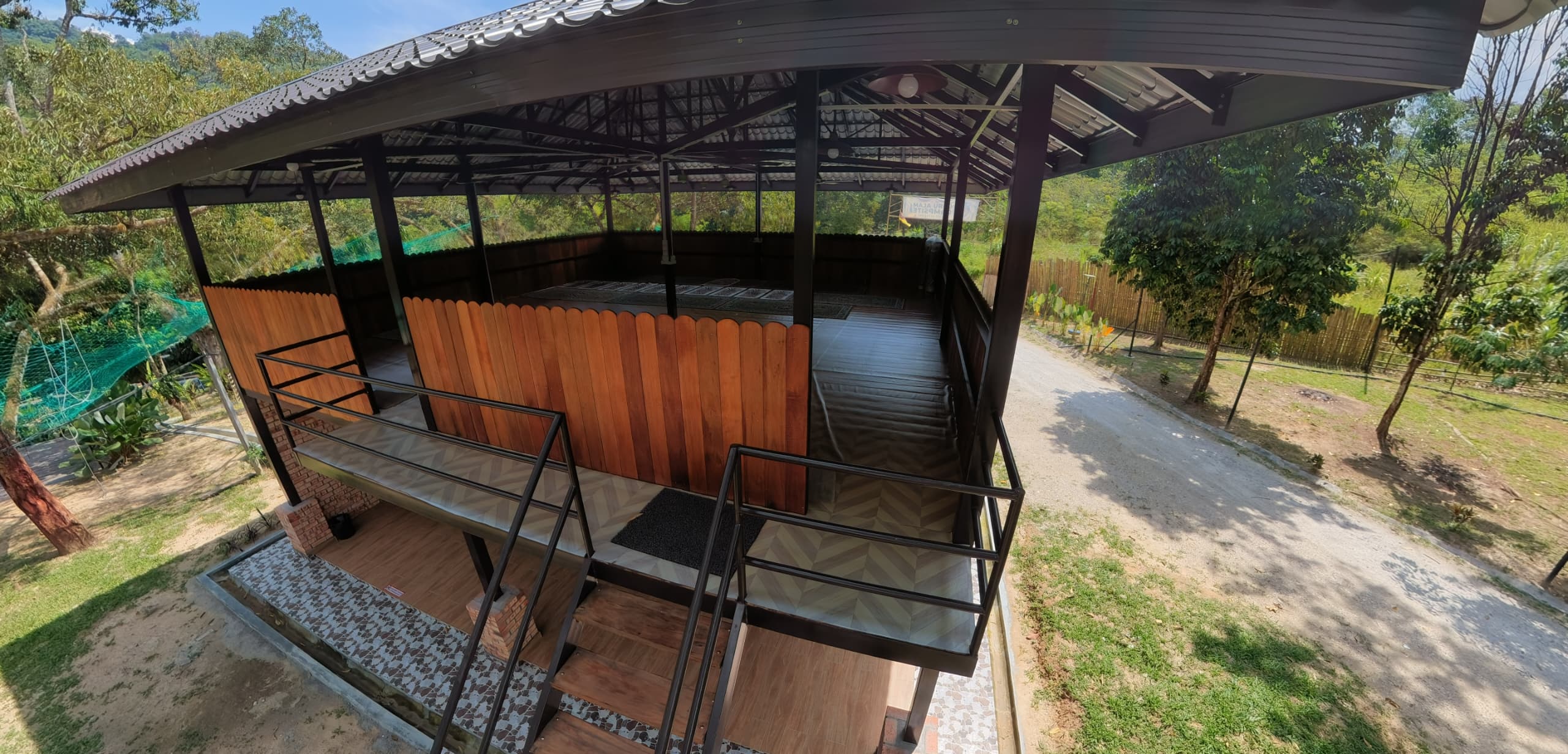 Raised wooden surau with a covered prayer area